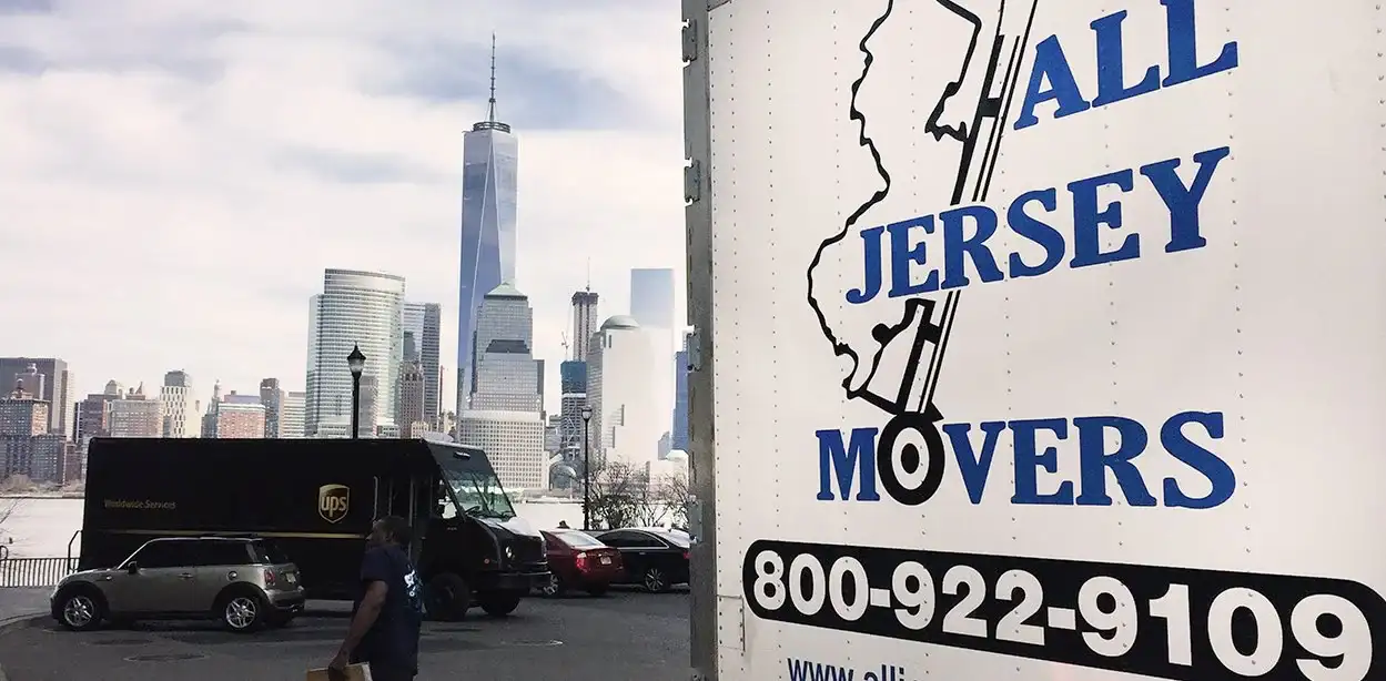 A white truck from All Jersey Moving and Storage is standing in the parking